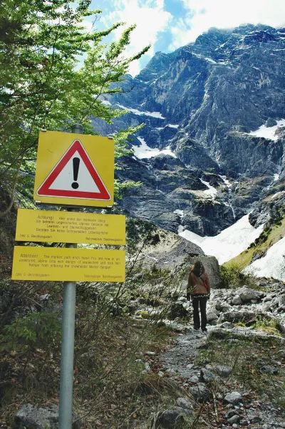 Information sign on mountain against sky